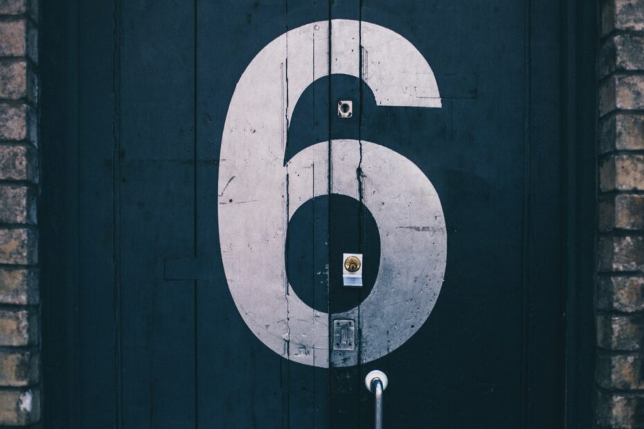 macro photography of blue wooden door painted with number 6